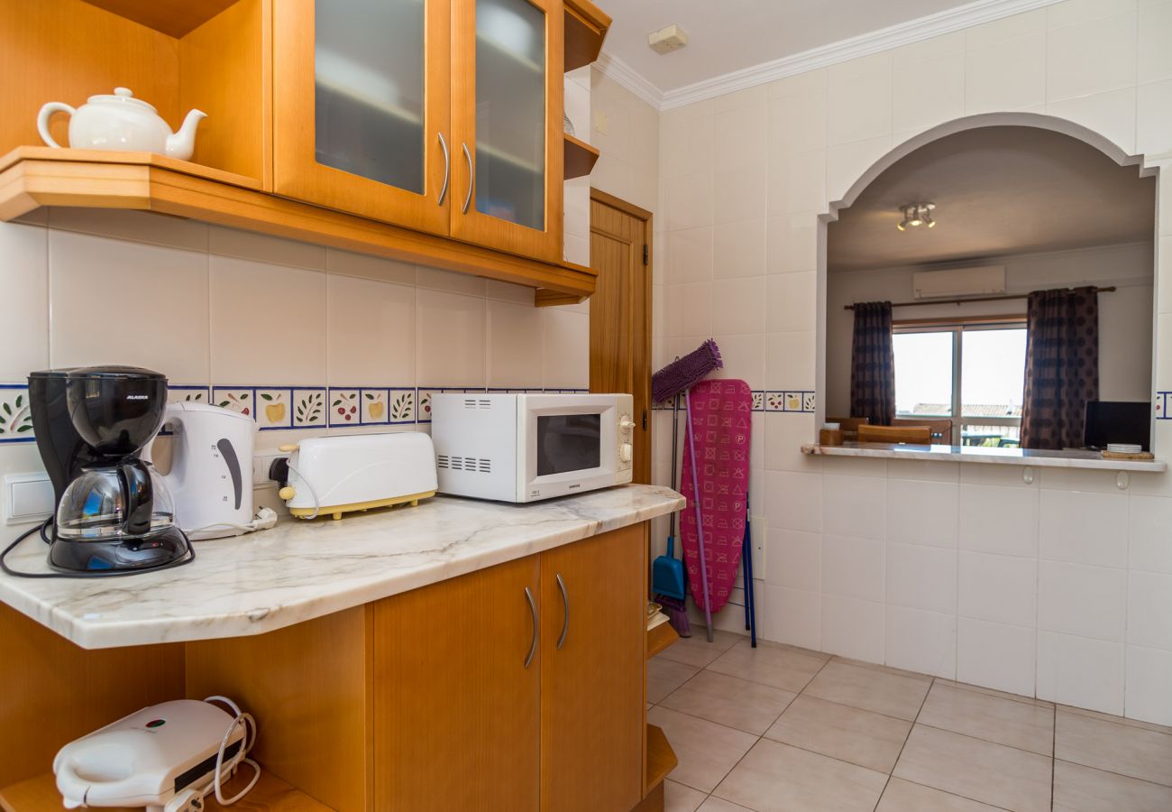 cristaluz kitchen with cupboards, batch to dining area, coffee machine, toaster, microwave and kettle