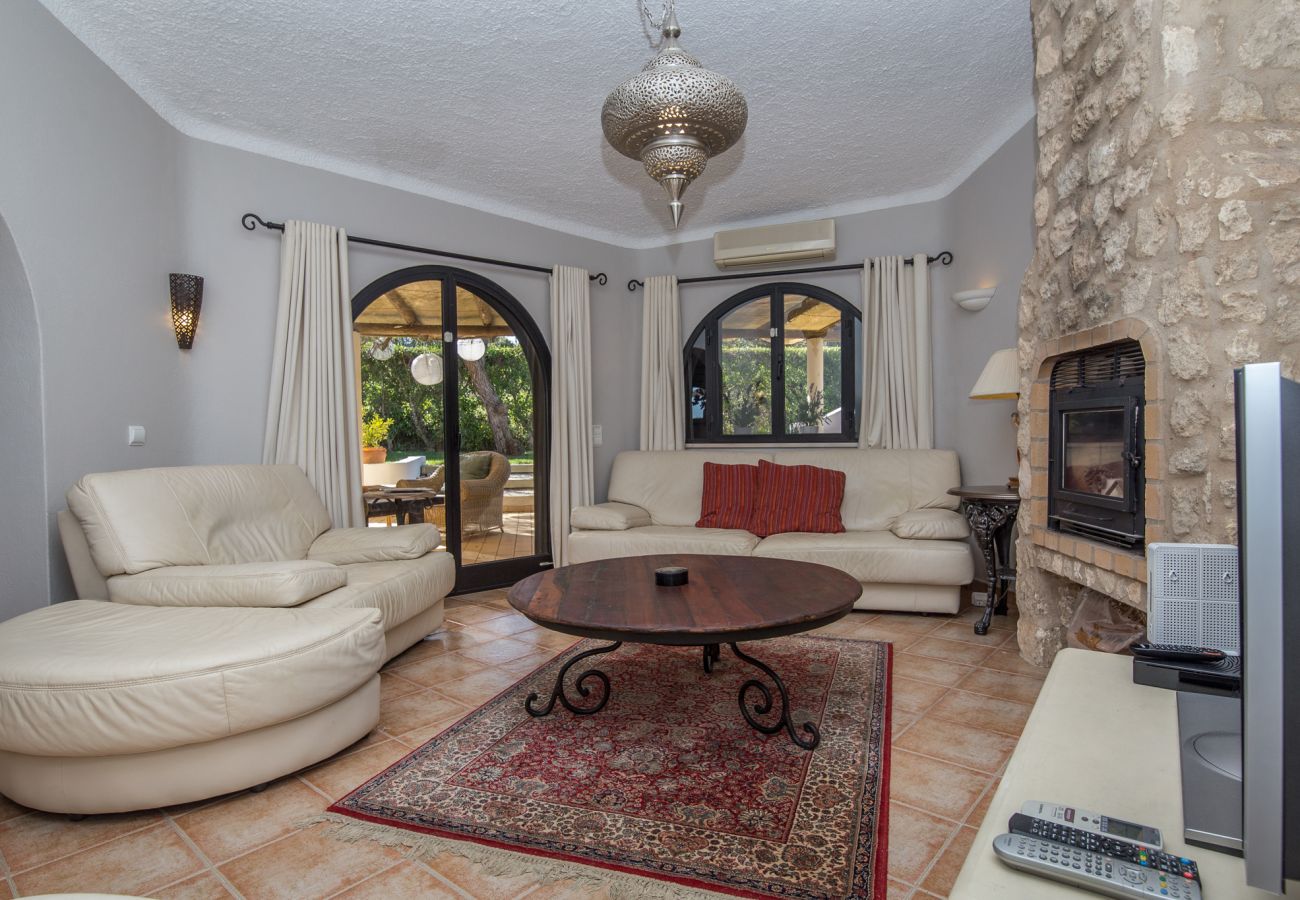 Living room with sofas and French doors opening onto terrace