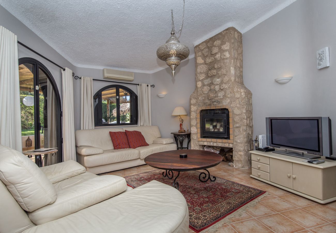 living room with log-burner and flat-screen tv
