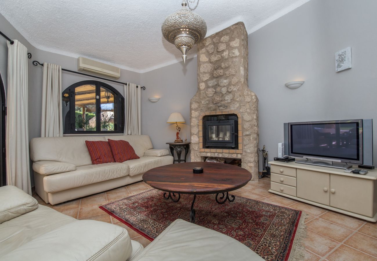 Living room with fireplace, flat-screen tv, Frech doors onto terrace