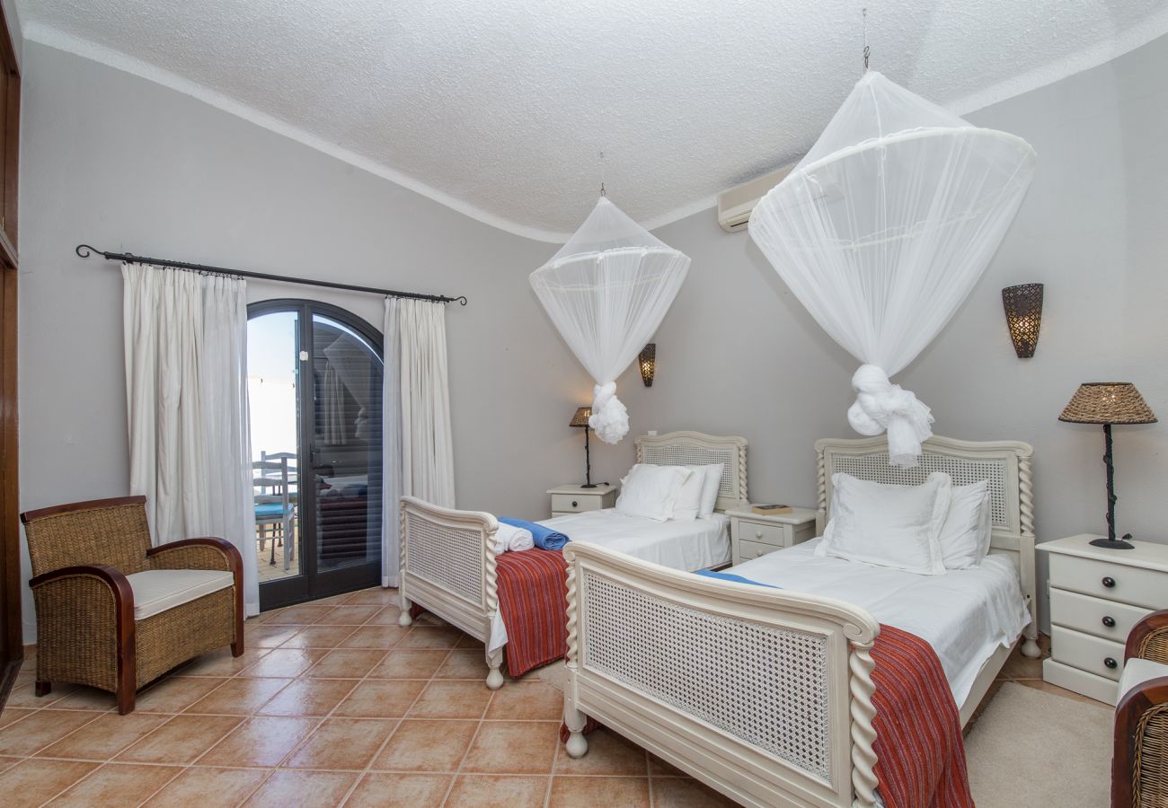 twin bedroom mosquito nets, air conditioning, integrated wardrobe