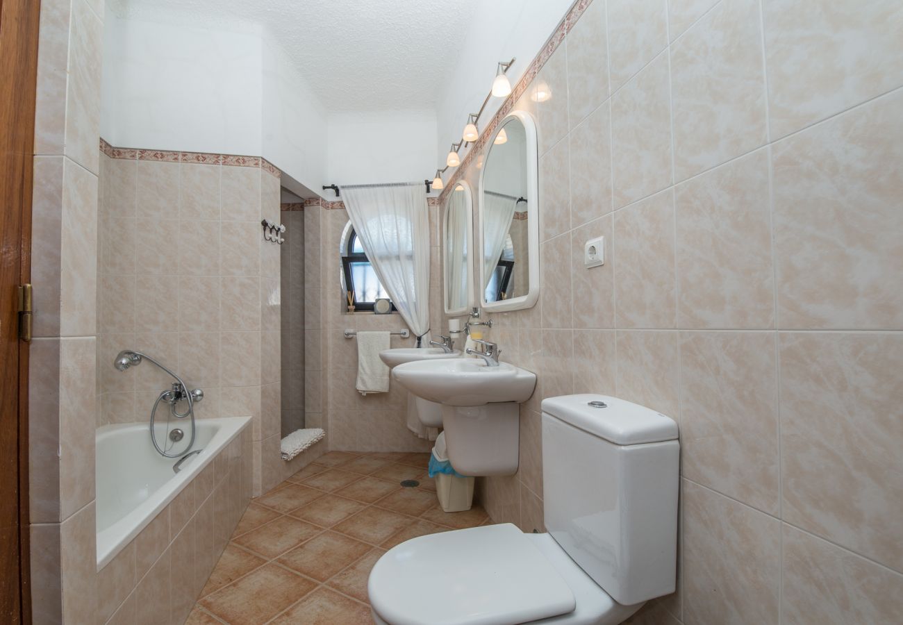 Master bedroom en-suite bathroom with two basins, bath, WC and walk-in shower