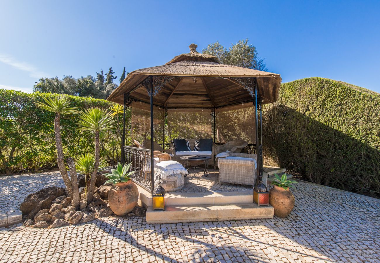 pergola with firepit and comfortable seating