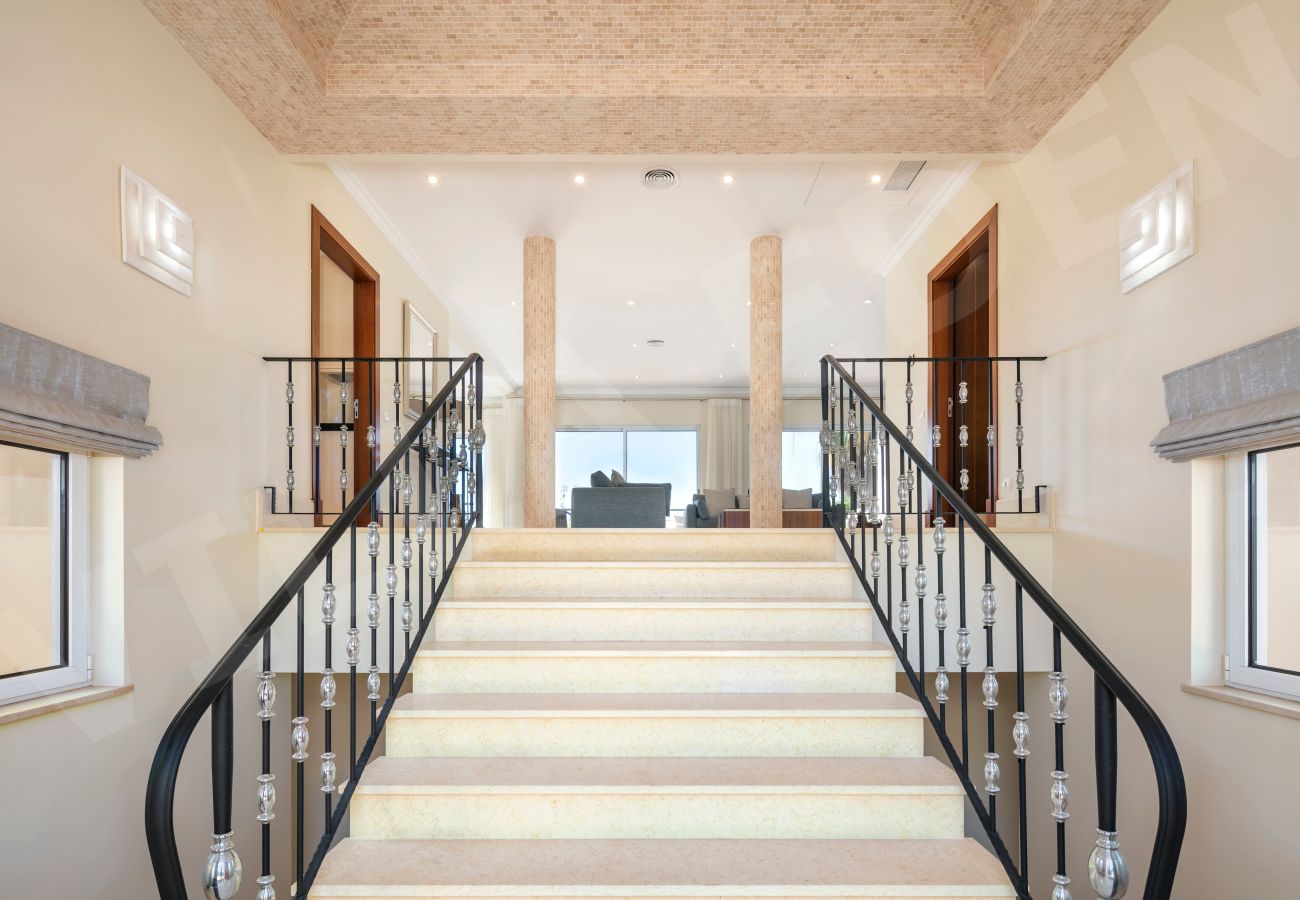 Elegant staircase with iron railings and open-plan interior at Villa Eden in Carvoeiro, Algarve