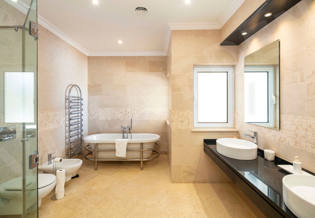 Luxury bathroom with freestanding bathtub and double sinks at Villa Eden