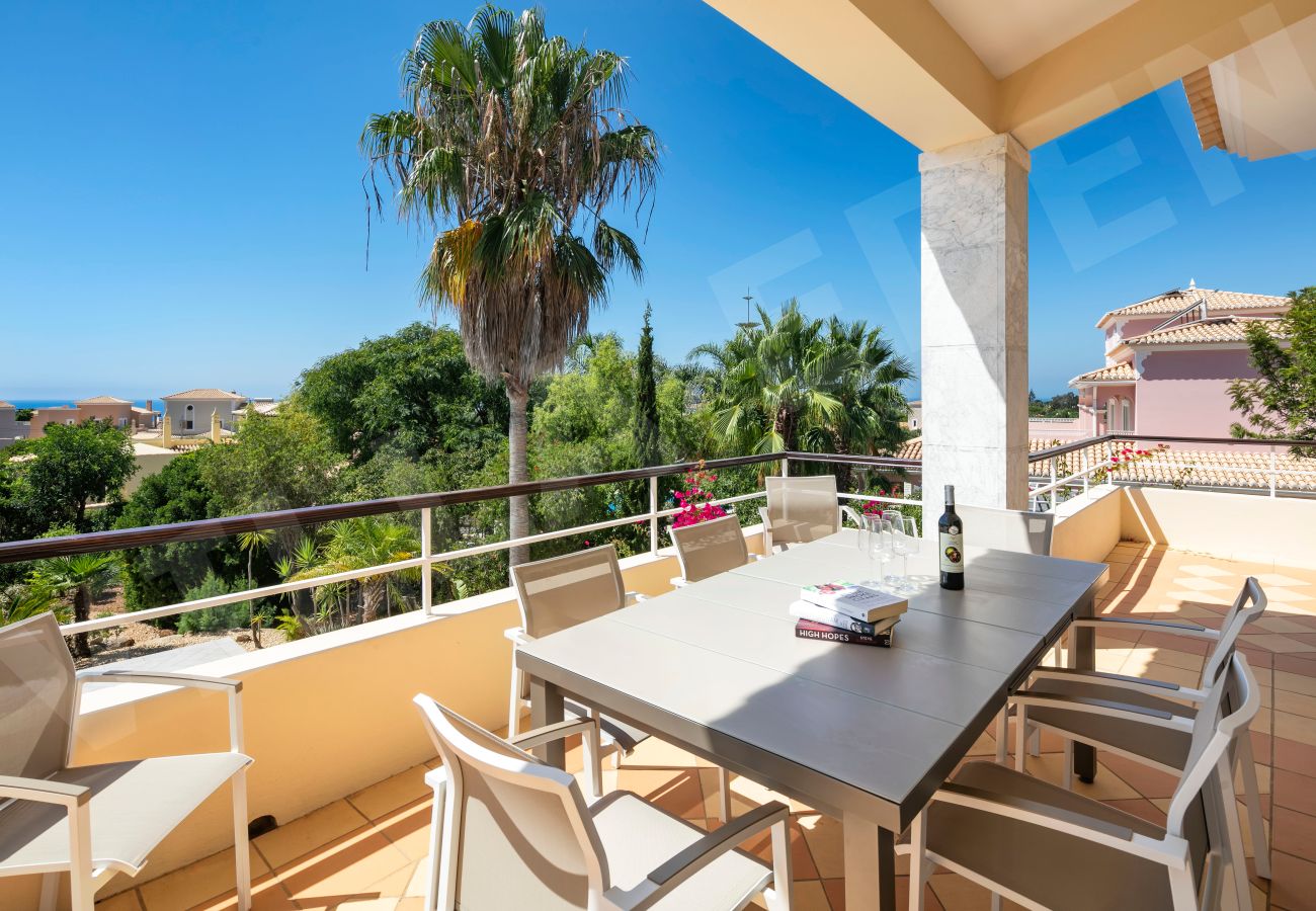 Outdoor terrace dining area with sea view at Villa Eden in Carvoeiro