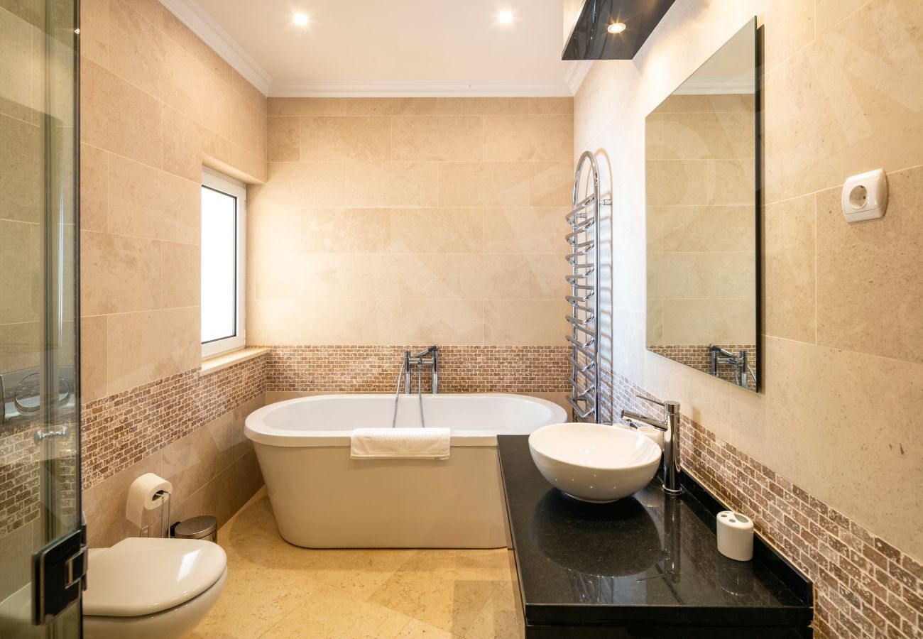 Ensuite bathroom with freestanding tub and modern finishes at Villa Eden in Carvoeiro