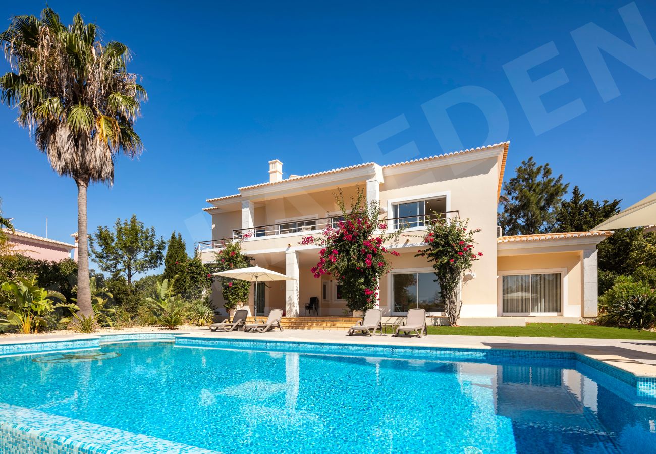 View of Villa Eden with private pool, loungers, and garden in Carvoeiro