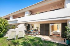 Garden with outdoor dining table, sun loungers, and covered terrace at 813 Alporchinhos Algarve